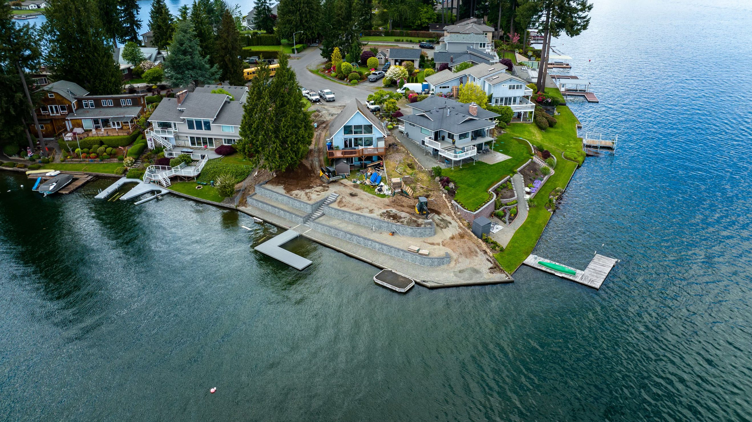 A waterfront property with a dock and landscaped yard.