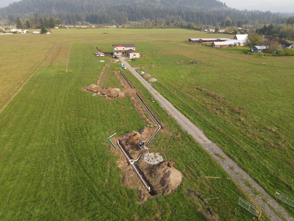 Construction site for pipeline or utility installation in a rural area.